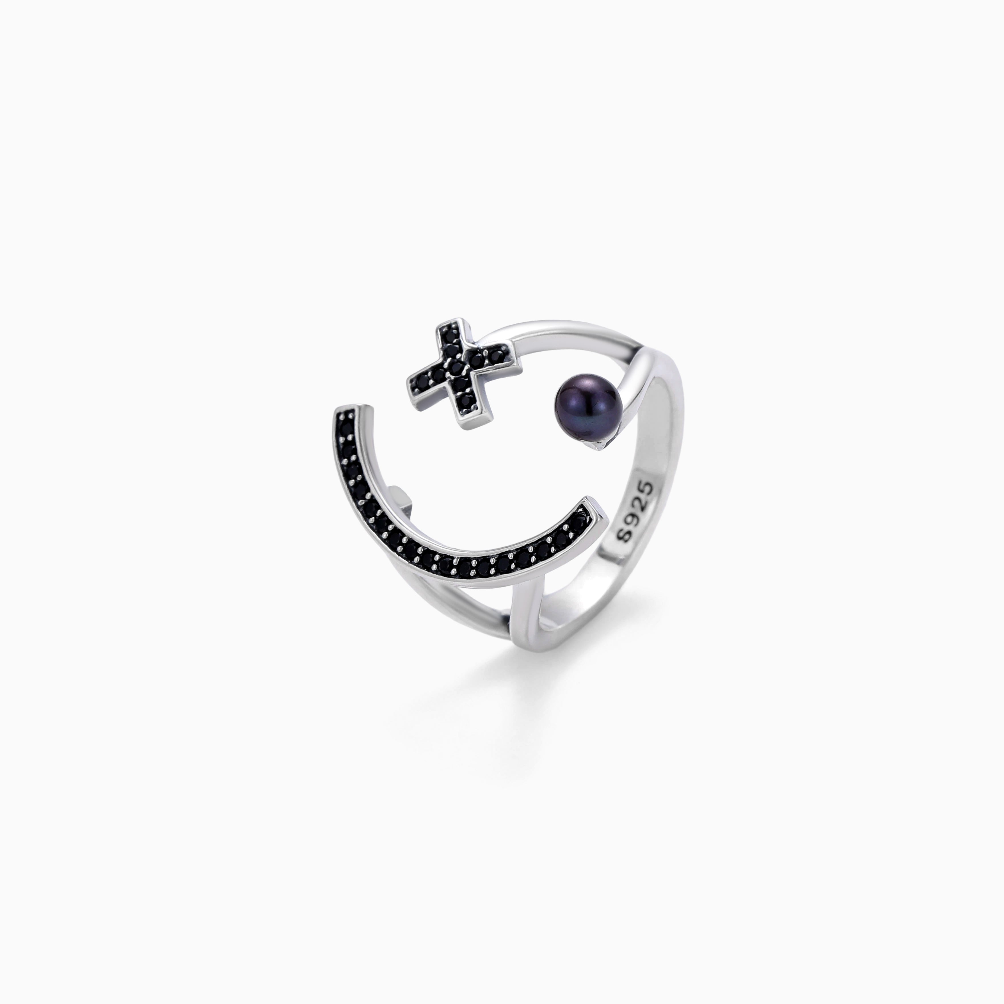 A GOTHIC CROSS RISES OVER BLACK CZ IN STERLING SILVER